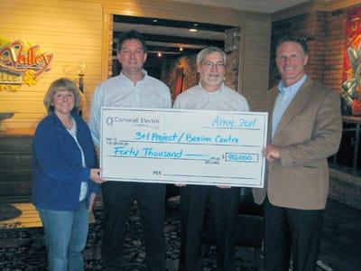 People holding a cheque donated to the Benson Centre